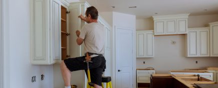 Man installing kitchen cabinets door