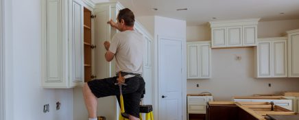 Man installing kitchen cabinets door