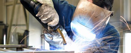 welder works in metal construction - construction and processing of steel components