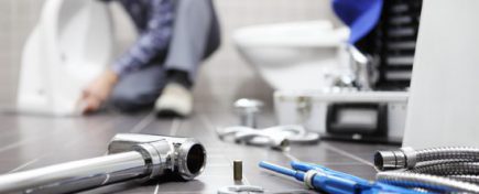 plumber at work in a bathroom, plumbing repair service, assemble and install concept