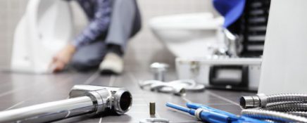 plumber at work in a bathroom, plumbing repair service, assemble and install concept