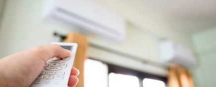 Concept of save power energy save sustainability world. Hand push down button air conditioner remote and turning off working machine