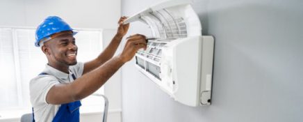 Technician Repairing Air Conditioner
