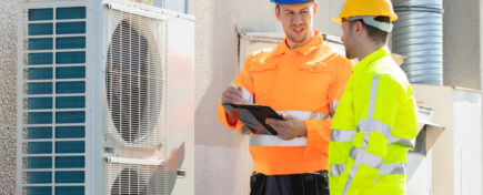 Two HVAC professionals on the job after HVAC technician training