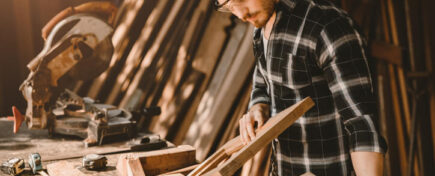 Male cabinet maker in a workshop after completing his cabinet making diploma program