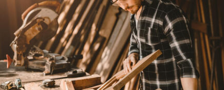 Male cabinet maker in a workshop after completing his cabinet making diploma program