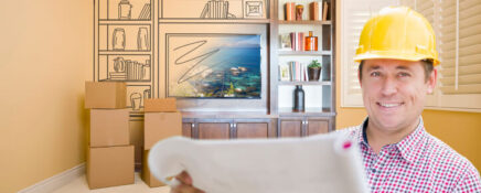 A home renovation technician assessing a renovation project after completing his home renovation training