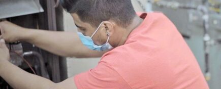 An HVAC professional working on an installation after completing HVAC technician training