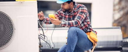 HVAC technician working on an air conditioning system after completing his HVAC technician training