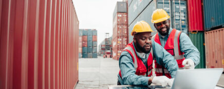 A pair of male operation managers at a warehouse after logistics management training